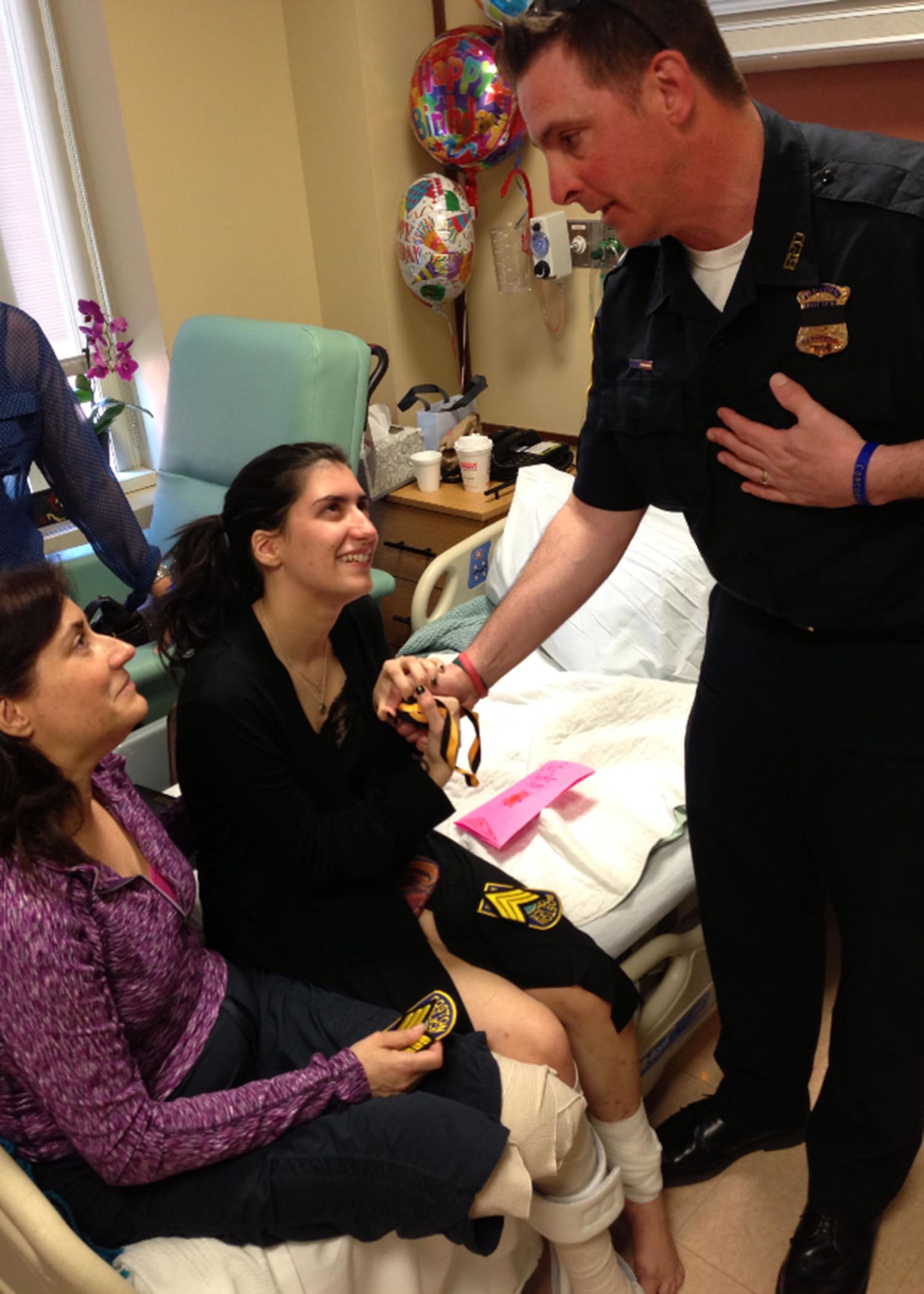 Image: Sydney Corcoran meets a first responder who helped her after the Boston Marathon bombing