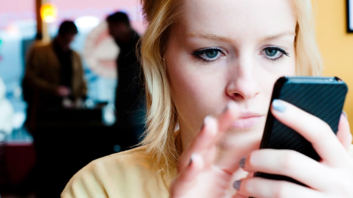 A young woman uses a smart phone