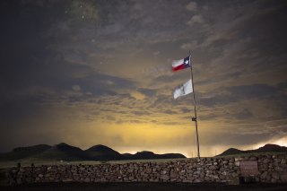 Image: A Texas state flag flies at an entrance to Cibolo Creek Ranch, Texas, in this 2015 photo.