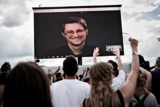 Image: American whistleblower Edward Snowden is seen on a screen as he delivers a speech during the Roskilde Festival in Roskilde