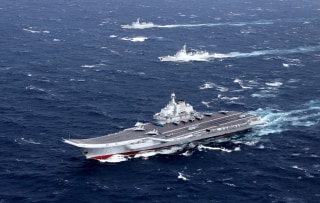 Image: China's Liaoning aircraft carrier with accompanying fleet conducts a drill in the South China Sea