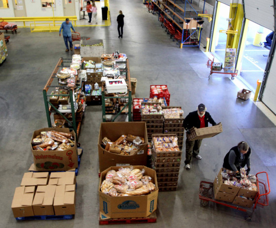 Volunteers gather food at the New Hampshire Food Bank in Manchester, N.H., to be delivered around the state. The temporary increase in food stamps expires Oct. 31, meaning for millions of Americans, the benefits that help them put food on the table every month won't stretch as far as they have for the past four years. 