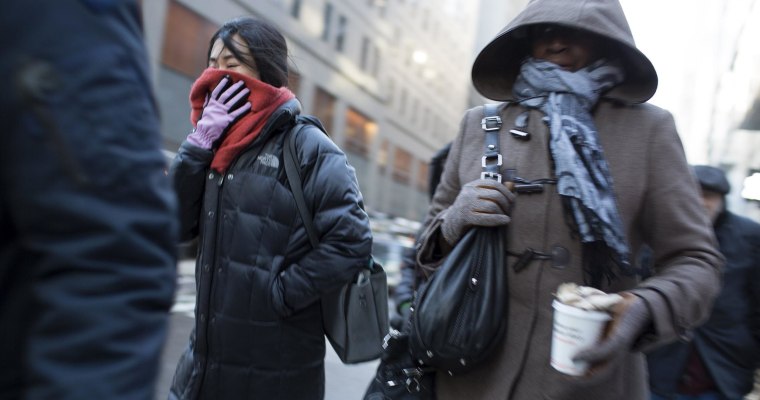 People make their way through the streets of New York City on Thursday, Jan. 23, 2014. 