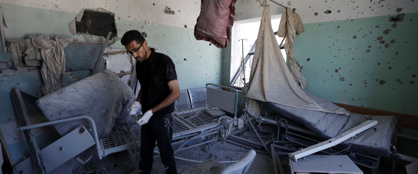 Image: A Palestinian employee inspects damages at the Al-Aqsa Martyrs hospital