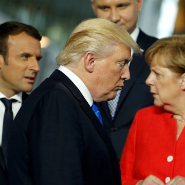 Image: President Donald Trump walks past French President Emmanuel Macron and German Chancellor Angela Merkel 