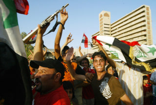 Image: Iraqi supporters celebrate the victory of their country's football team against Saudi Arabia for the final of the Asian Football Cup 2007
