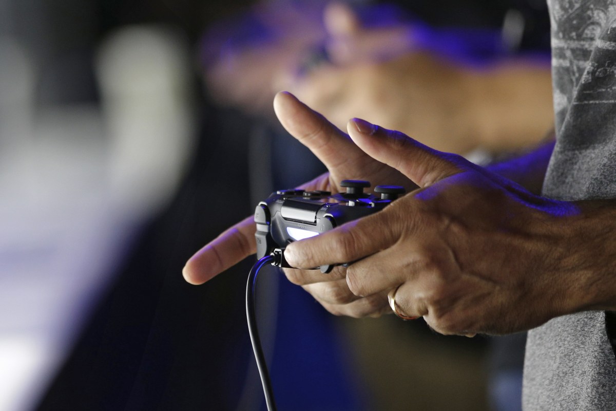 Close-up of hands holding PS4 Controller