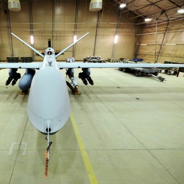 A U.S. Air Force MQ-9 Reaper drone sits armed with Hellfire missiles and a 500-pound bomb in a hanger at Kandahar Airfield, Afghanistan