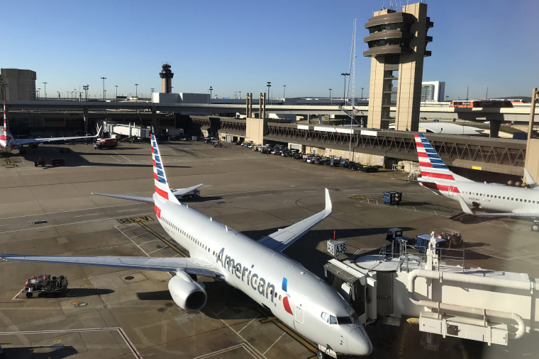 Image: An American Airlines plane sits at the gate at Dallas Fort Worth International Airport