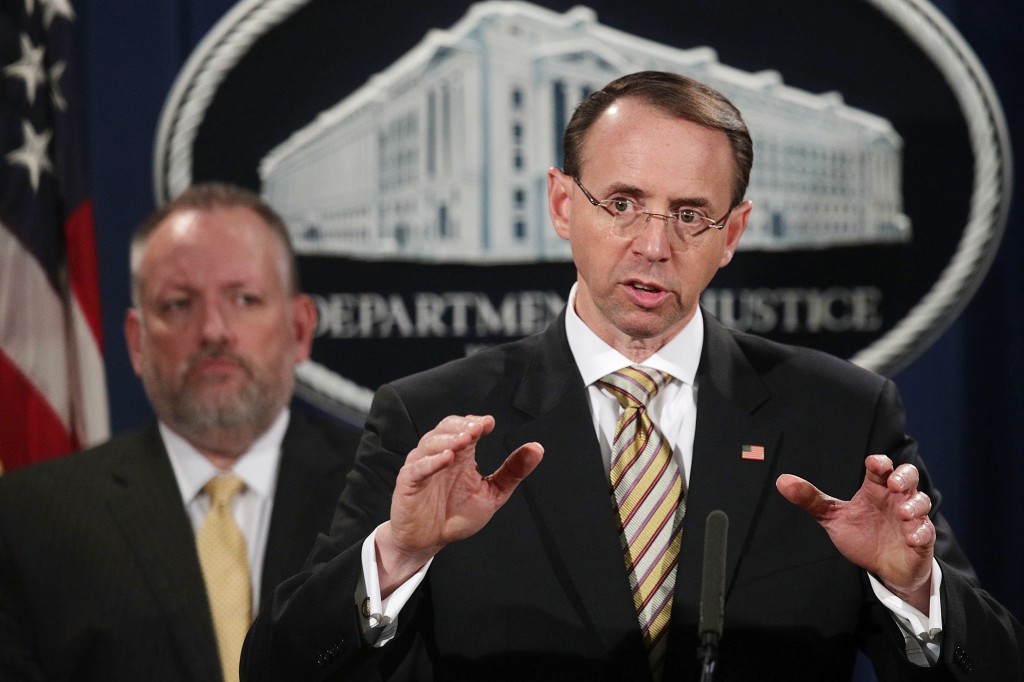 Image: Deputy U.S. Attorney General Rod Rosenstein speaks as Acting DEA Administrator Robert Patterson listens during a news conference