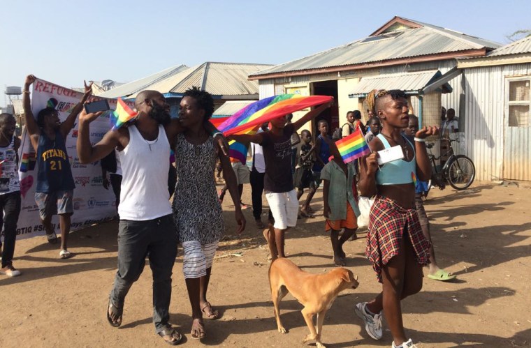 Image: Participants hold rainbow flags during an LGBTQ pride event at the Kakuma Refugee Camp in Kenya
