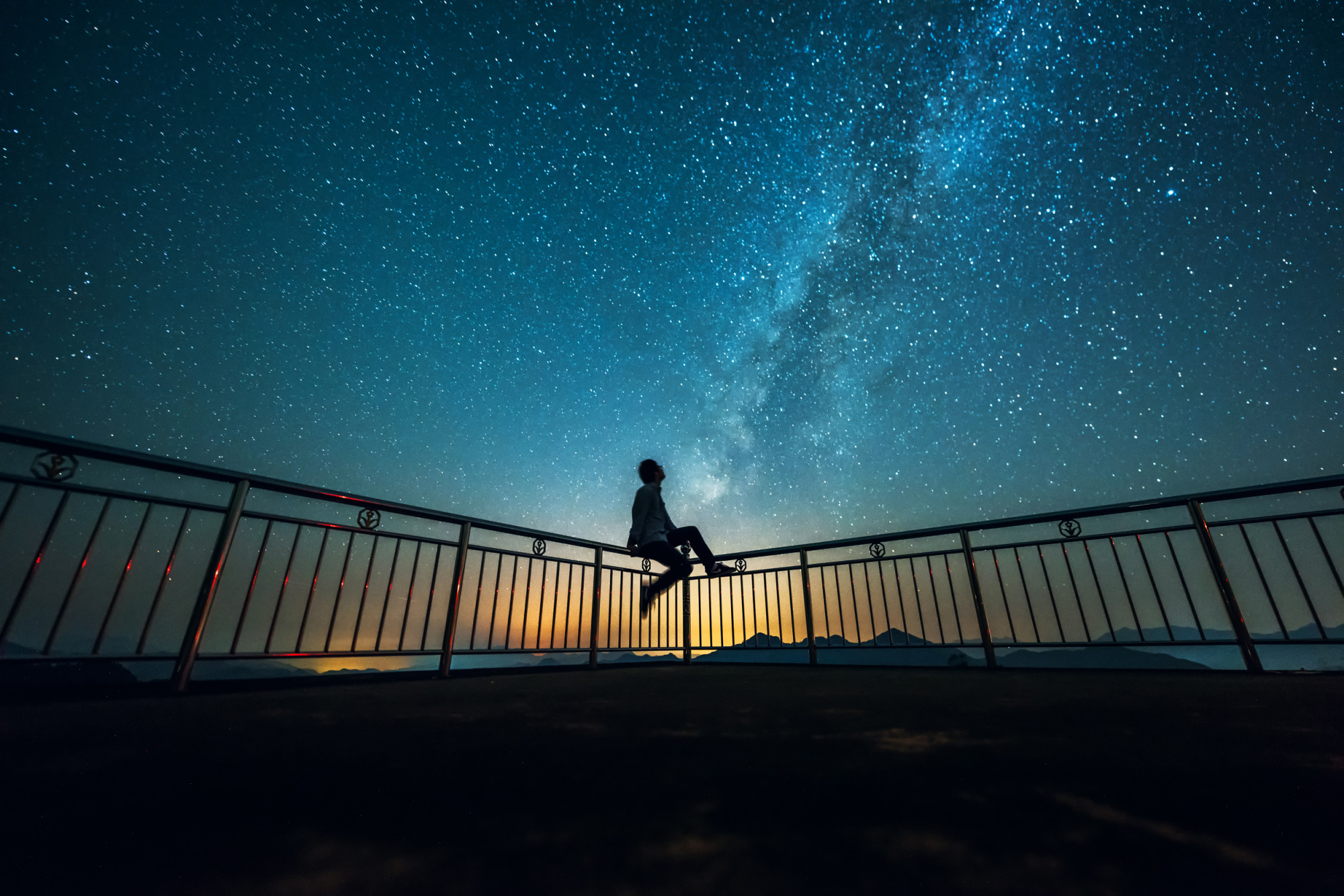 image of a male figure staring out into the night sky