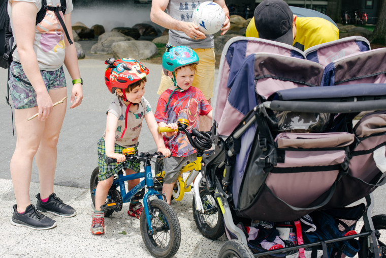 Image: Zyler,3, and Kadyn,3, run into friends while riding their bikes home