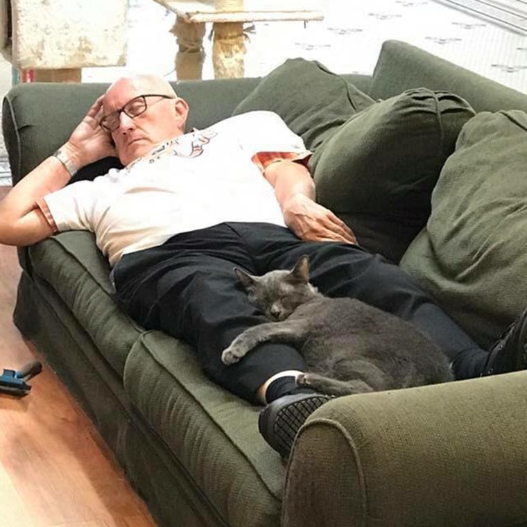 Volunteer Terry naps with cat Louis