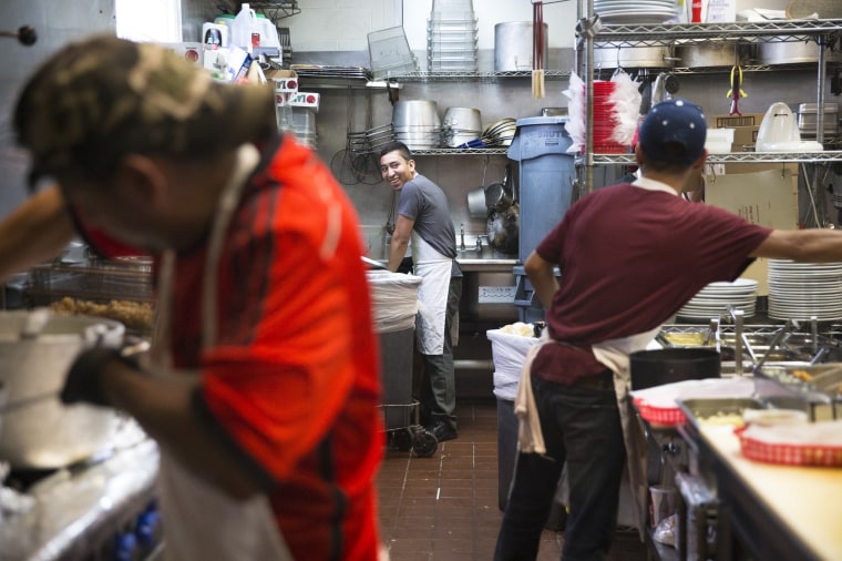Image: Uber Dorantes, Miguel Angel, and Cristian Lopez work in the kitchen at Taqueria del Sol