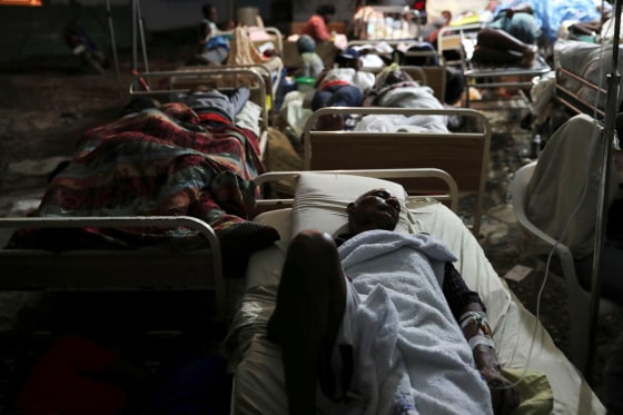 Image: People injured in an earthquake that hit northern Haiti late on Saturday, sleep in a tent, in Port-de-Paix