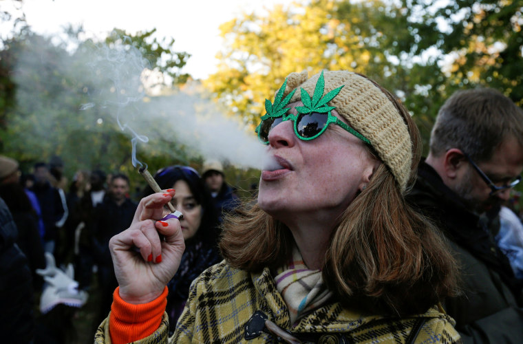 Image: A woman smokes a joint on the day Canada legalizes recreational marijuana at Trinity Bellwoods Park in Toronto