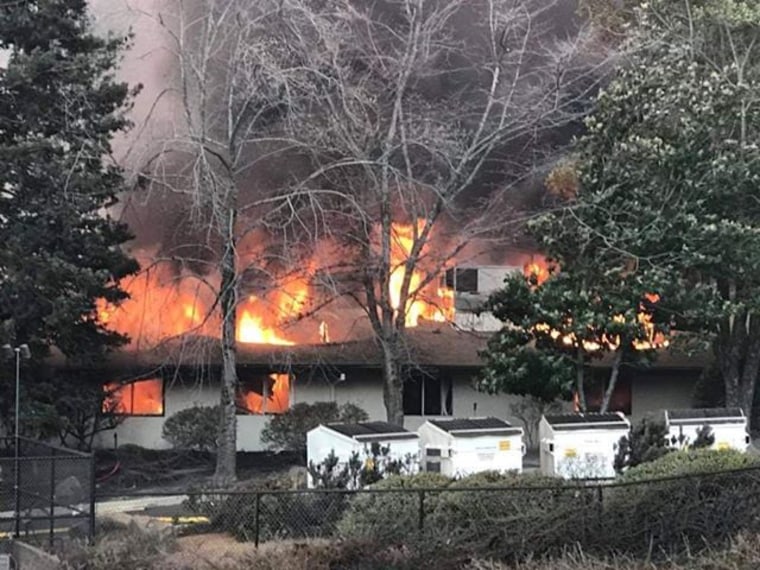 The back of Adventist Health Feather River Hospital in Paradise, California, burns as it is overtaken by the Camp Fire.