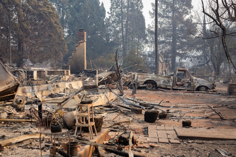 Search and rescue teams, often made up of volunteers, search for human remains among the debris of burned down homes on Nov. 16, 2018 in Paradise, California.