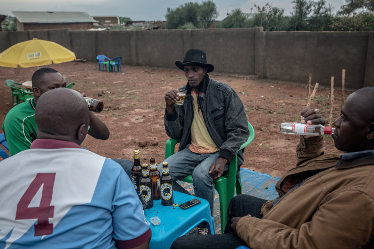 Image: Men drink beer and spirits in a bar in Nakivale refugee settlement in southwest Uganda.