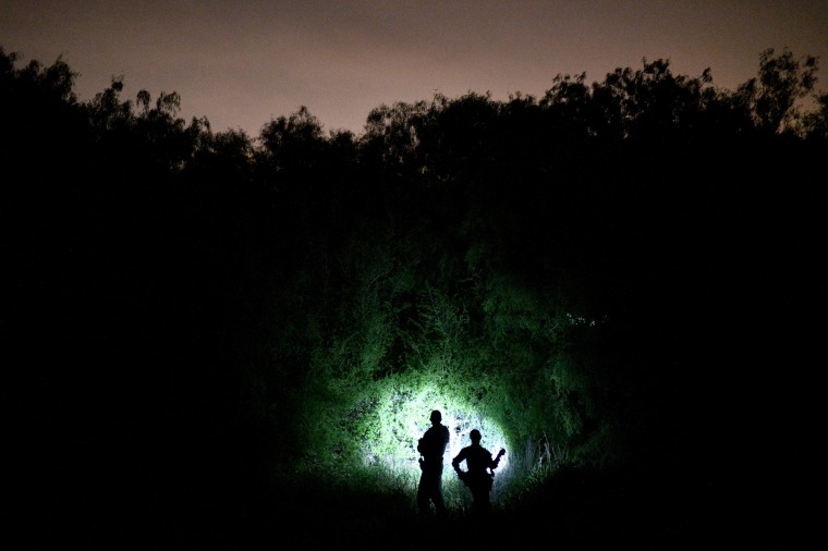 Image: Border patrol agents search from undocumented migrants crossing the Rio Grande near Palmview, Texas, on April 6, 2019.