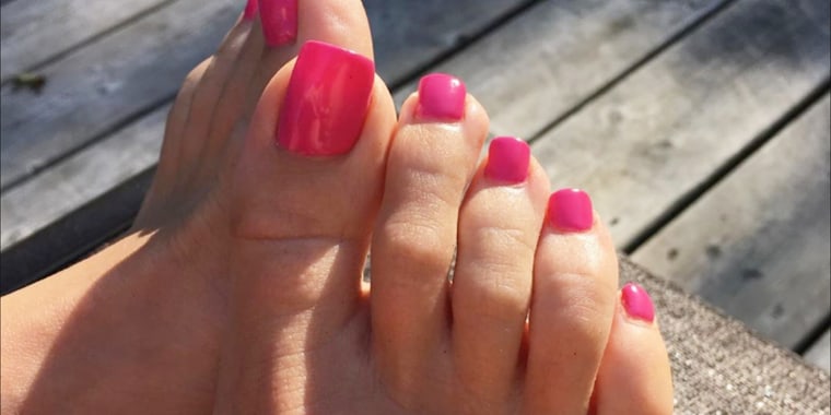 Long, fake toenails painted pink