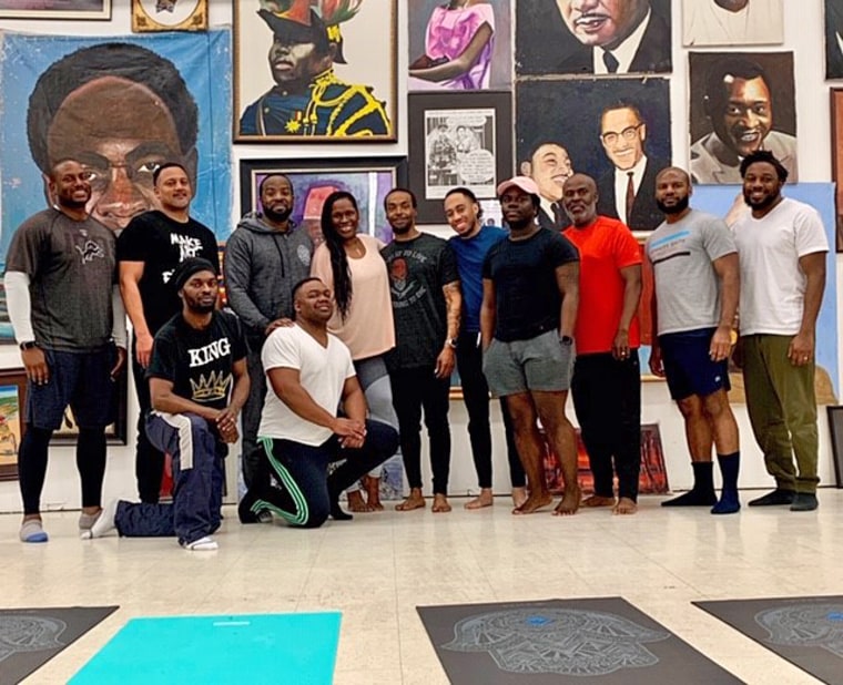 Sherri Doucette, Founder, Litehouse Wellness, stands with attendees of "Broga - Yoga for the Brothers" class at the Pan African Connection in South Dallas.