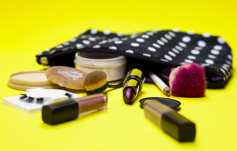 Cosmetics and Make Up Equipment on Yellow Background