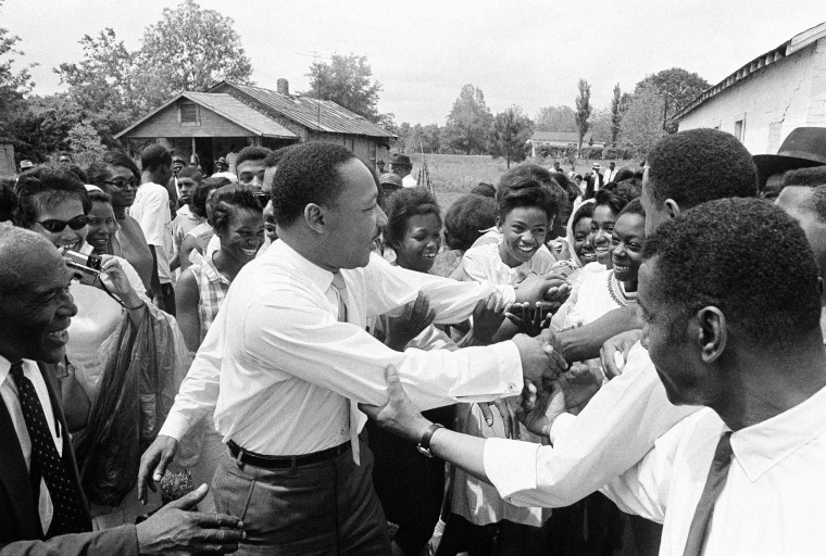 Image: King shakes hands with a group of girls after addressing a political rally in Lisman, Alabama