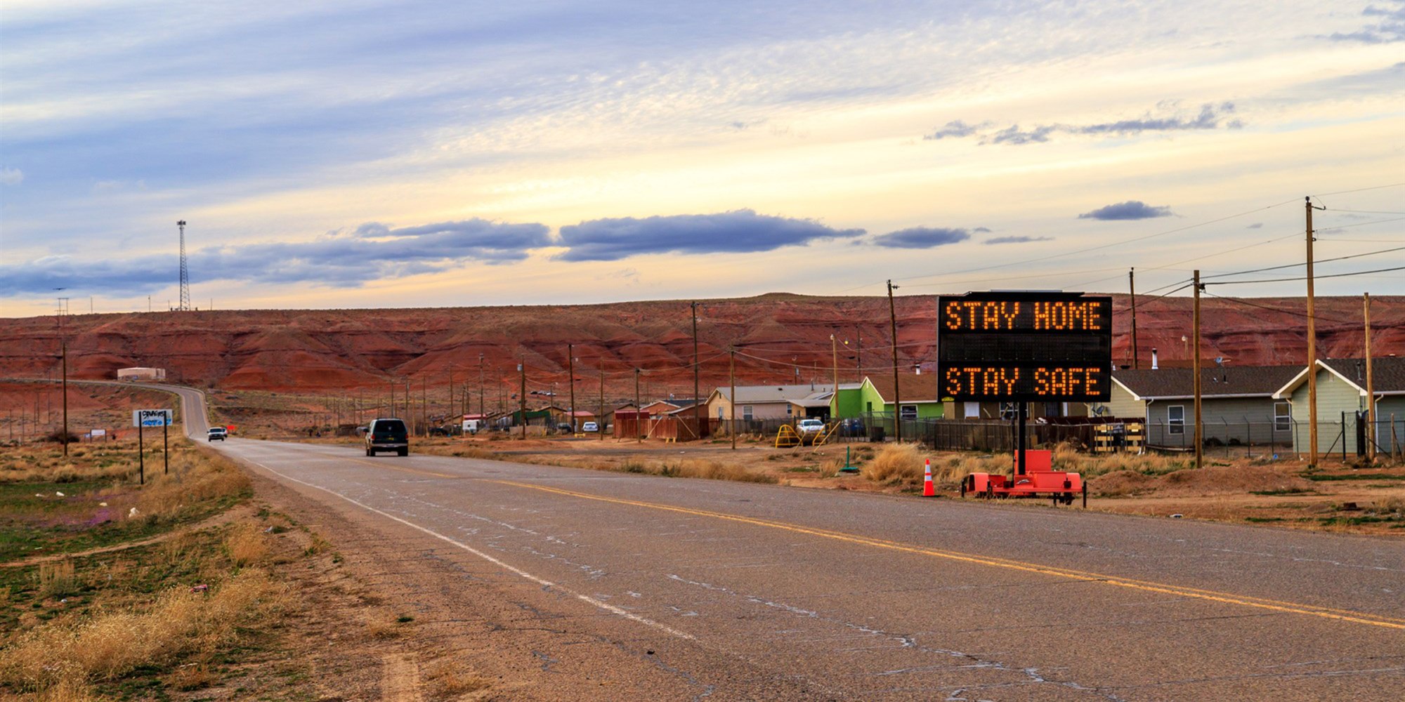A sign in Many Farms, Ariz., tells Navajos to stay home as the tribal nation experiences an increasing number of coronavirus cases.