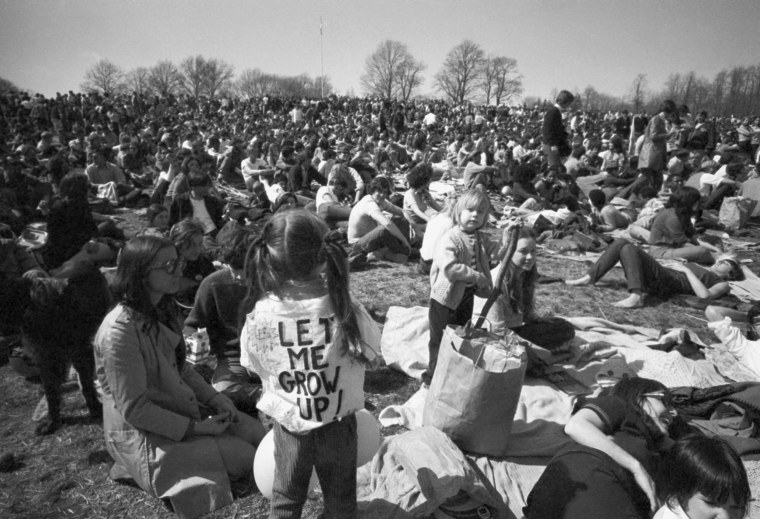 A young girl wears a "Let Me Grow Up" sign as residents mark Earth Day in Philadelphia's Fairmount Park on April 22, 1970.
