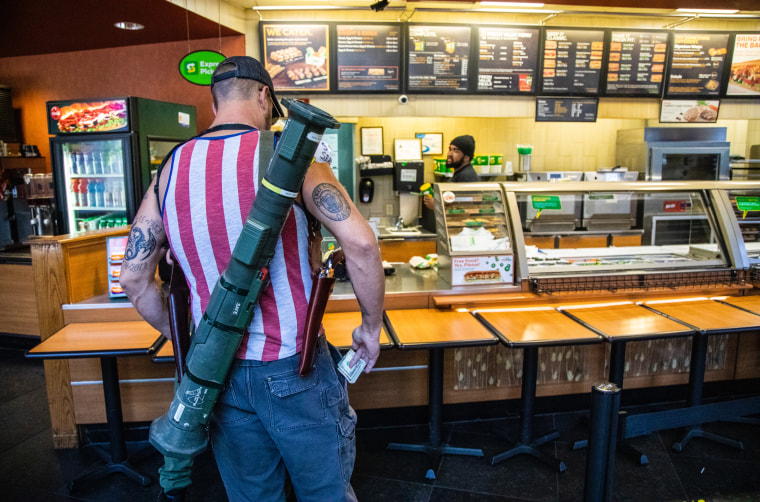 Several armed demonstrators protesting North Carolina's stay-at-home order visited a sandwich shop in Raleigh on Saturday, May 9, 2020, and were captured in photographs that went viral.