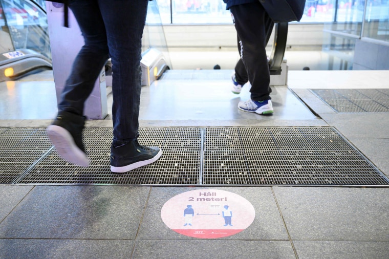 Image: A sticker on a street to ask people to keep social distances amid the new coronavirus pandemic in central Stockholm