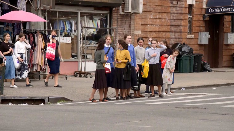 A crowd of girls gather at a crosswalk in the Borough Park neighborhood of Brooklyn, N.Y., which was hit by the virus early on.