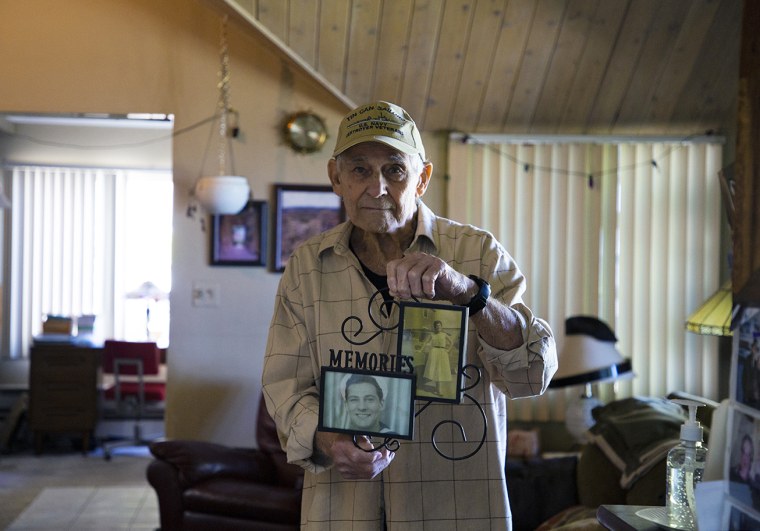 Vincent Randazzo holds a frame containing photos of him and his wife, Rose Violet Randazzo.
