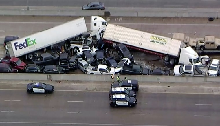 Image: Cars and trucks are wedged together after a morning crash on the ice covered I-35 in Fort Worth