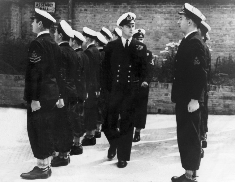 Prince Philip as a naval officer inspecting soldiers of the naval school in Corsham, England in 1946 .