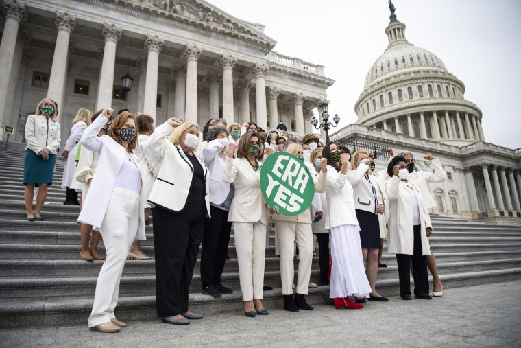 Democratic lawmakers stand on the House steps after passing a joint resolution to remove the Equal Rights Amendment deadline in Washington March 17, 2021.