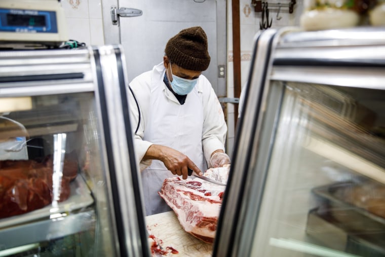 A butcher prepares a cut of meat in the halal grocery store Fertile Crescent in Brooklyn, N.Y., on May 5, 2021.